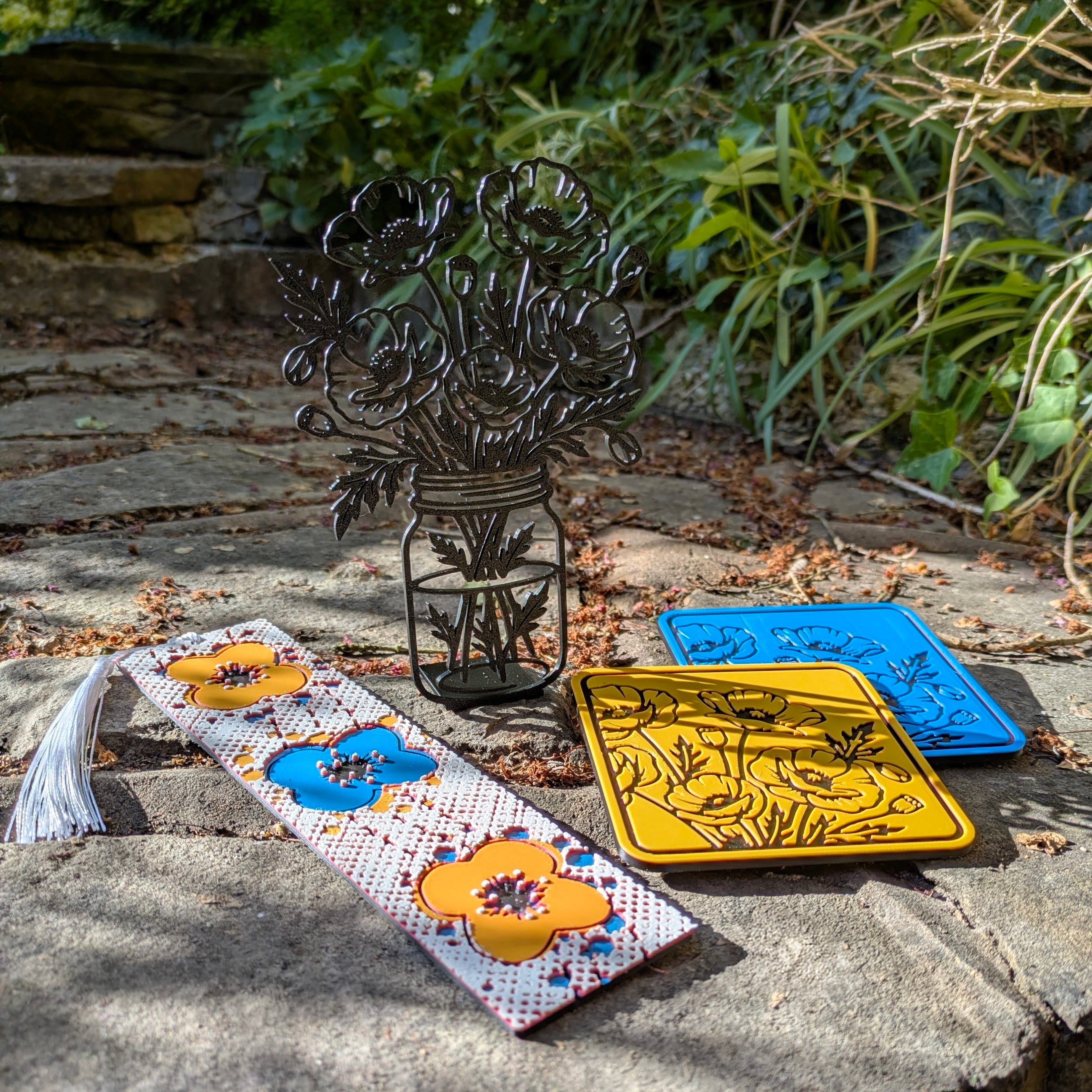 Decorative coasters with floral designs on a stone surface outdoors